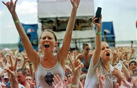 The Woodstock '99 music festival in Rome, New York, was meant to honor the 30th anniversary of the iconic 1969 Woodstock event — that was before the mud, fires, and rioting ruined all the fun. People gather among the mud and trash before a performance July 26. Two naked men stroll through the grounds of Woodstock '99 on July 24.